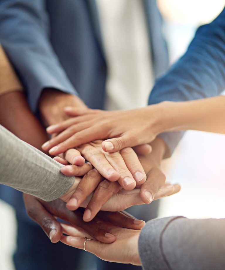 Achieving success as one. Cropped shot of a group of colleagues joining their hands in unity