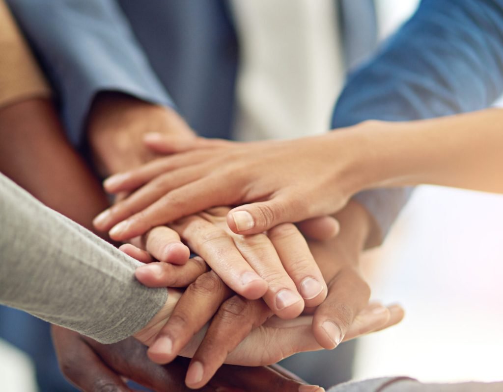 Achieving success as one. Cropped shot of a group of colleagues joining their hands in unity